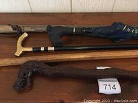 Full view of all five items arranged on wooden surface showing various handles and shafts.