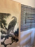 View of the Asian eagle painting and the Fijian vatuele tapa cloth hung adjacent on a wall.