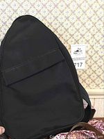 Black nylon Norm Thompson backpack showing front and zipper pocket.