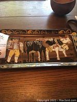 Ceramic rectangular tray with painted figures of a boy and horses in earthy tones