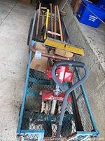 Overall view of cart loaded with Mantis tiller and long-handled tools