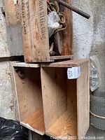 Wooden crates with labels and visible wear, holding various vintage hardware items.