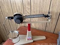 Front view of the Ohaus Dial-O-Gram balance scale showing the weighing pan, body, and base.