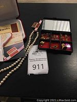Overview of Majorica necklace, rings and assorted earrings in presentation boxes