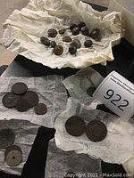 Collection of buttons and coins arranged on paper towels