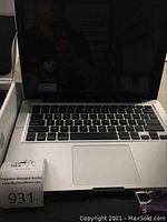 MacBook Pro open showing keyboard, trackpad and screen