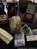 Mottled soapstone mug with handle and round metal medal in red velvet presentation box