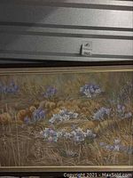 Front view of framed painting showing purple crocus flowers in golden grass field