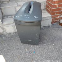 Front view of the industrial paper shredder showing the full body and waste bin with some surface scratches.