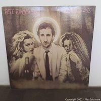 Front cover of Pete Townshend Empty Glass vinyl album showing Pete Townshend with two women, one blonde and one with dreadlocks.