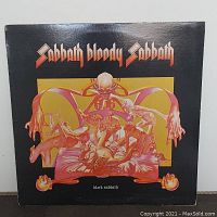 Front cover of Black Sabbath Sabbath Bloody Sabbath vinyl album showing detailed surreal artwork with humanoid figures and skull motif.