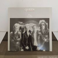 Front cover of Queen The Game vinyl LP record showing the band members in black and white.