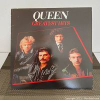 Front cover of the Queen Greatest Hits vinyl album showing band members and title.