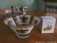 Two-tier glass Chip dip bowl set with ornate brown and gold floral and swirl enamel designs on thick clear glass, displayed on wooden table with natural light.