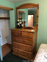 Full view of pine dresser with five drawers and attached mirror.
