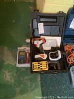 Black and Decker VPX cordless drill with battery, charger in carrying case, and screwdrivers.