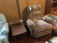 Photo showing MCM style table next to upholstered recliner chair for scale