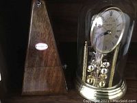Photo of Heirloom wooden pyramid metronome with brand label visible.
