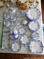 Overhead view of blue Dainty Blue china pieces on table including plates, cups and saucers