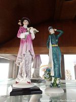 Wide view of both figurines together showing relative size and details