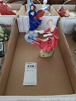 Front view of the two Royal Doulton figurines, showing May and Fiona with their flowing dresses and hats.
