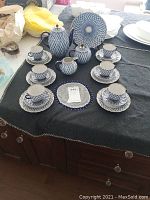 Overview of entire tea service on black cloth