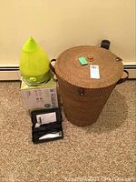 Overview of the hamper, humidifier, and hair shears with case on carpeted floor.