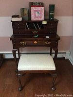 Full frontal view of the complete desk with drop leaf top, drawers, letter compartments, and Ethan Allen padded seat in front.