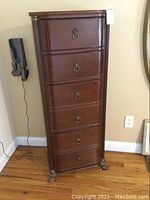 Front view of the tall lingerie chest showing all six drawers and bronze-tone accents.