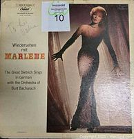 Front cover of autographed Marlene Dietrich record album with her photo in elegant gown and inscription 'To Lew Marlene'.
