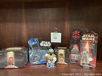 Photo showing all five Star Wars collectibles arranged on a wooden shelf with a green numbered tag (60) in the center