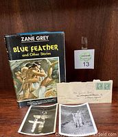 Photo showing the front cover of the Zane Grey book "Blue Feather and Other Stories" alongside the addressed letter envelope and two black and white photographs.