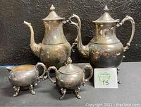 Front view of all four pieces in the Sheridan silver on copper coffee and tea service set.