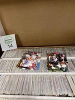 Open cardboard storage box showing top row of trading cards with some foil accented cards on top