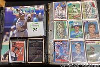 Photo of binder pages showing various baseball cards and the Beckett Baseball Card Monthly magazine
