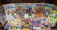Image showing over 20 comic books mostly The Mighty Thor and Thor titles in various conditions and cover art styles from vintage to modern.