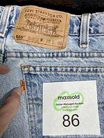 Back patch and orange Levi's tab on denim jeans showing size and model info