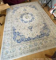 Full view of the rectangular rug in a room setting showing overall pattern and size.