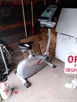 Side view of the Schwinn 150 exercise bike placed in a garage with surrounding items.