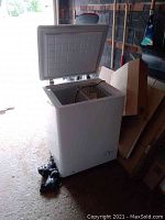 White Quick Frez chest freezer model CFO4WQ with lid open showing inside basket.