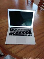 Open laptop front view showing keyboard, trackpad and screen