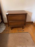 Front view of one night table showing overall design and finish