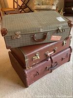 Three vintage suitcases stacked, showing tweed-patterned fabric suitcase with leather corners, medium brown leather suitcase, and large dark brown suitcase on carpet.