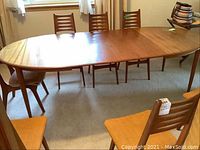 Full view of extended table with chairs in room