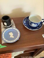 Overview of all items: JFK memorial pin plate, Jasperware toothpick holder, Wedgwood cup and saucer in blue and white classical design.