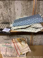 Multiple yardage pieces of floral patterned fabric stacked on shelving