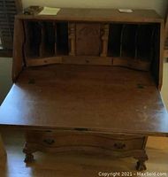 Open drop front showing inside compartments and writing surface of the tiger maple desk.