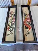 Both framed vintage Spanish bull fighter posters shown side by side on a table, each with black wooden frame and visible poster wear.