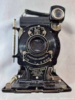 Front view of the Vintage No.1 Pocket Kodak camera showing lens, shutter controls, Eastman Kodak Co branding, model and stylus attachment.