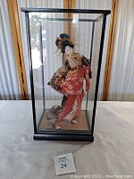 Full view of Geisha doll in glass display case from front showing doll and case dimensions.